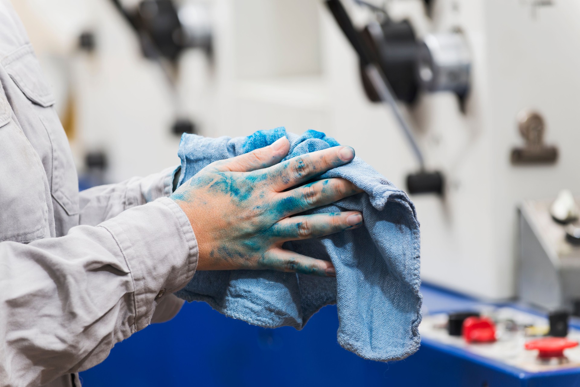 Female worker wiping hands with rag